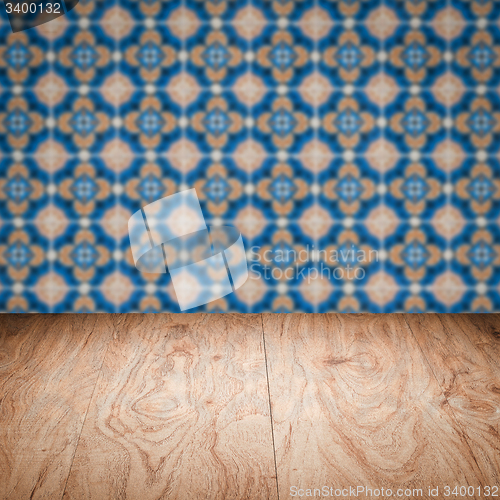 Image of Wood table top and blur vintage ceramic tile pattern wall