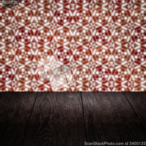 Image of Wood table top and blur vintage ceramic tile pattern wall