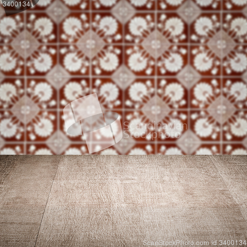 Image of Wood table top and blur vintage ceramic tile pattern wall