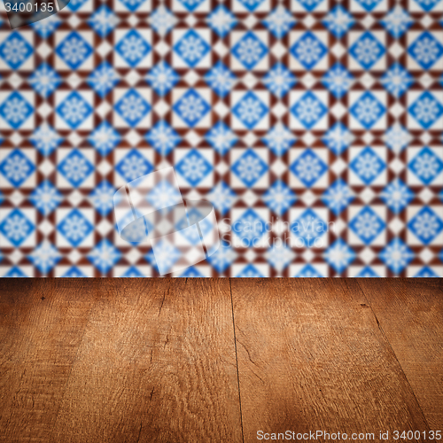 Image of Wood table top and blur vintage ceramic tile pattern wall