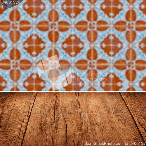 Image of Wood table top and blur vintage ceramic tile pattern wall