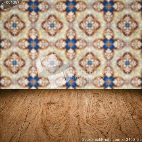 Image of Wood table top and blur vintage ceramic tile pattern wall