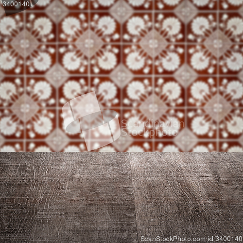 Image of Wood table top and blur vintage ceramic tile pattern wall