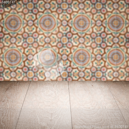 Image of Wood table top and blur vintage ceramic tile pattern wall