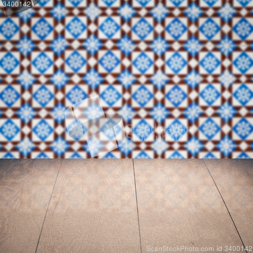 Image of Wood table top and blur vintage ceramic tile pattern wall