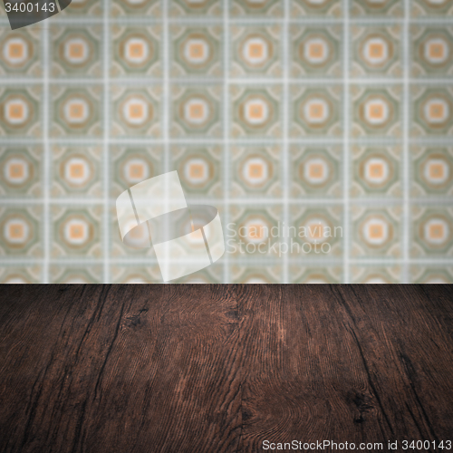 Image of Wood table top and blur vintage ceramic tile pattern wall