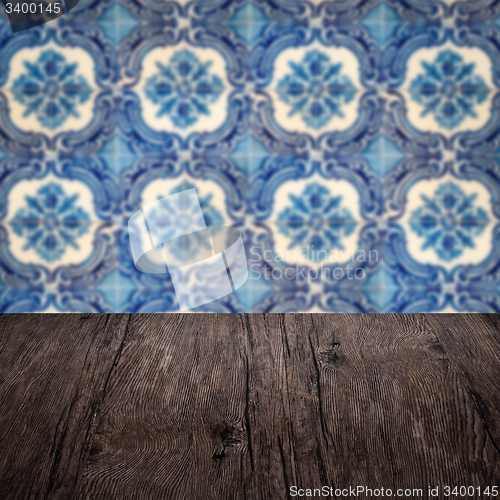 Image of Wood table top and blur vintage ceramic tile pattern wall