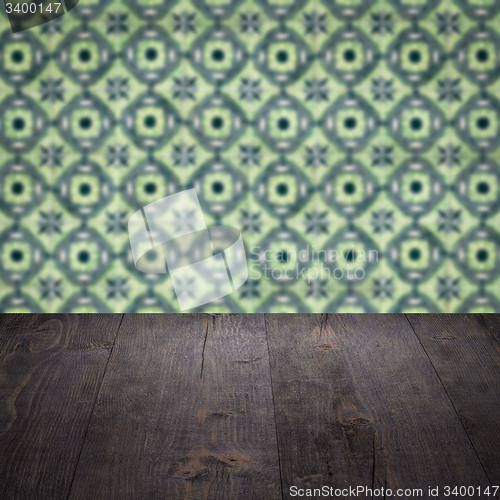 Image of Wood table top and blur vintage ceramic tile pattern wall