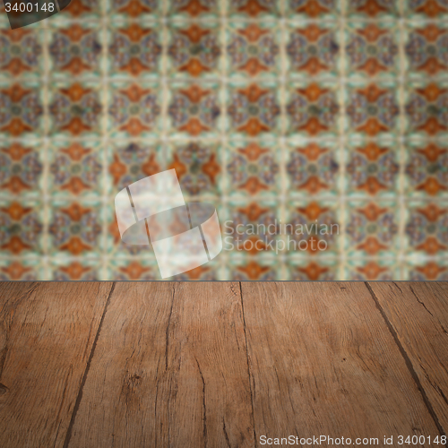 Image of Wood table top and blur vintage ceramic tile pattern wall