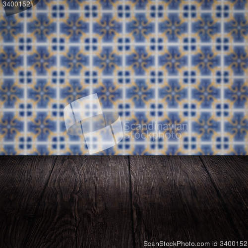Image of Wood table top and blur vintage ceramic tile pattern wall