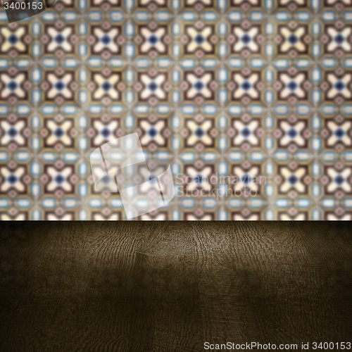 Image of Wood table top and blur vintage ceramic tile pattern wall