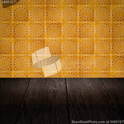 Image of Wood table top and blur vintage ceramic tile pattern wall