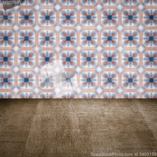 Image of Wood table top and blur vintage ceramic tile pattern wall