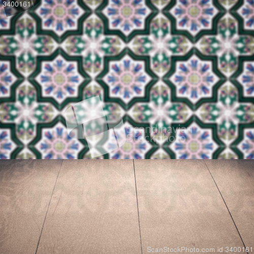Image of Wood table top and blur vintage ceramic tile pattern wall