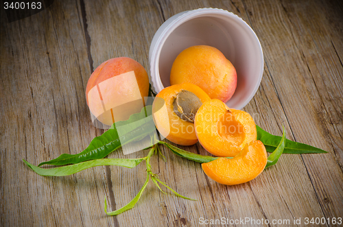 Image of Apricots on wooden table.