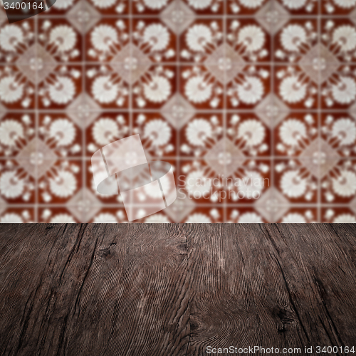Image of Wood table top and blur vintage ceramic tile pattern wall