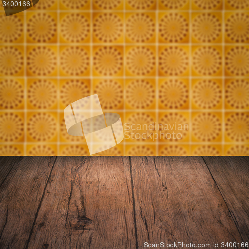 Image of Wood table top and blur vintage ceramic tile pattern wall