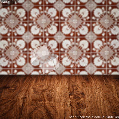 Image of Wood table top and blur vintage ceramic tile pattern wall