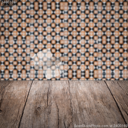 Image of Wood table top and blur vintage ceramic tile pattern wall