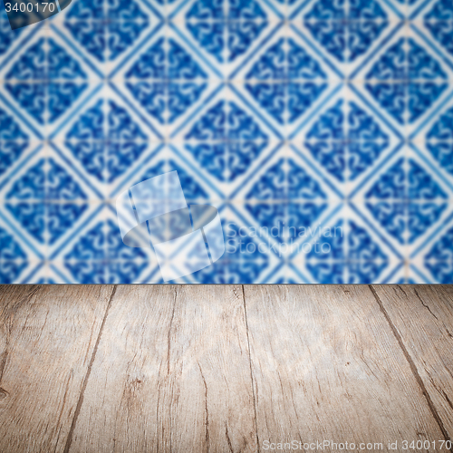 Image of Wood table top and blur vintage ceramic tile pattern wall