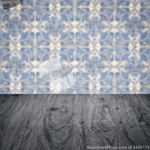 Image of Wood table top and blur vintage ceramic tile pattern wall