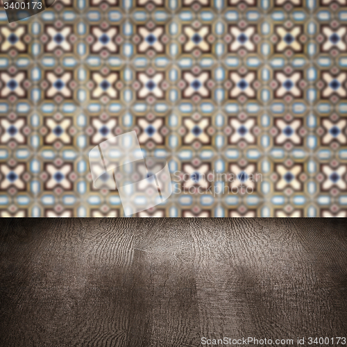 Image of Wood table top and blur vintage ceramic tile pattern wall