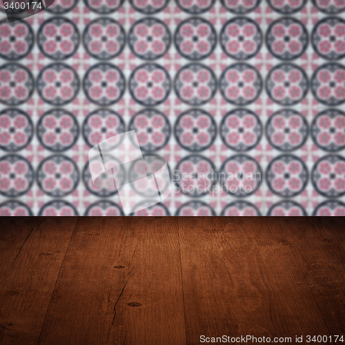 Image of Wood table top and blur vintage ceramic tile pattern wall