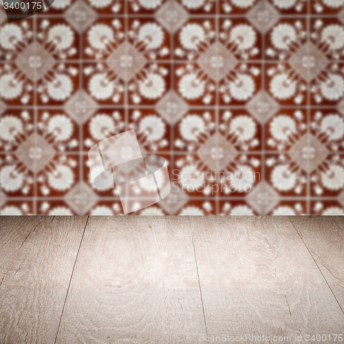 Image of Wood table top and blur vintage ceramic tile pattern wall