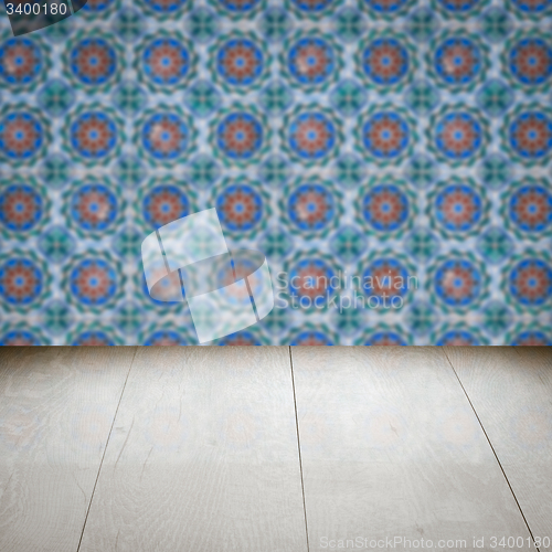 Image of Wood table top and blur vintage ceramic tile pattern wall