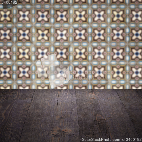 Image of Wood table top and blur vintage ceramic tile pattern wall