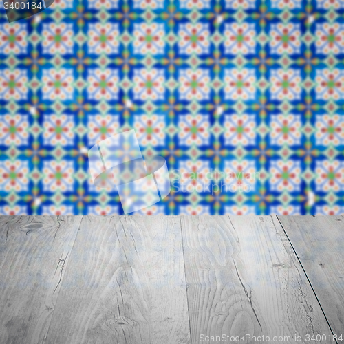 Image of Wood table top and blur vintage ceramic tile pattern wall