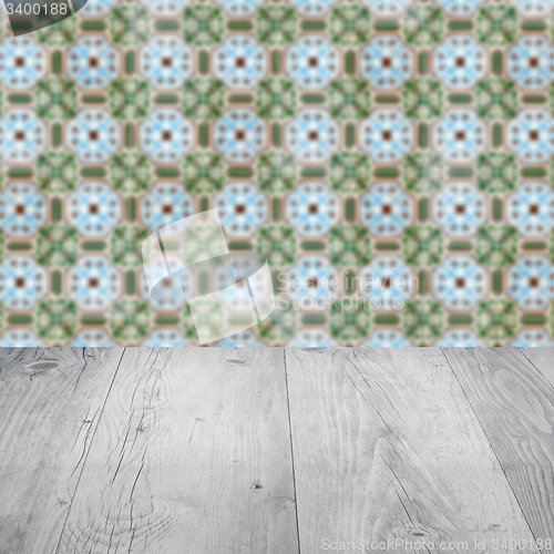 Image of Wood table top and blur vintage ceramic tile pattern wall