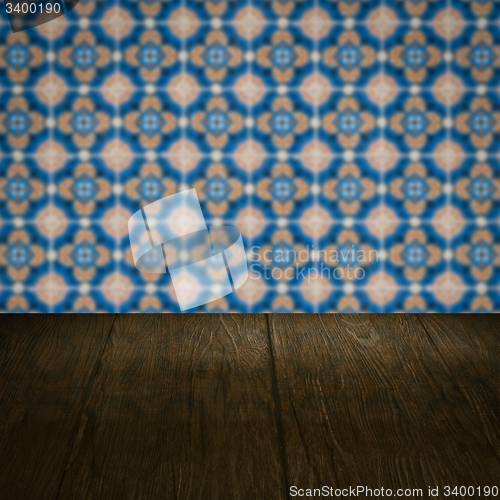 Image of Wood table top and blur vintage ceramic tile pattern wall
