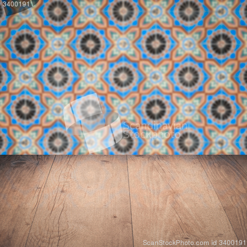 Image of Wood table top and blur vintage ceramic tile pattern wall