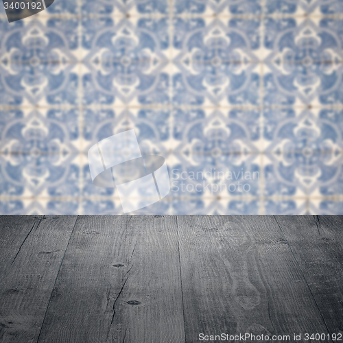 Image of Wood table top and blur vintage ceramic tile pattern wall