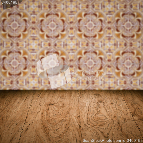 Image of Wood table top and blur vintage ceramic tile pattern wall