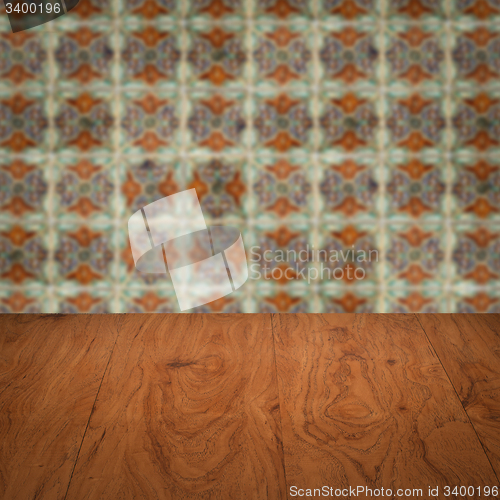 Image of Wood table top and blur vintage ceramic tile pattern wall