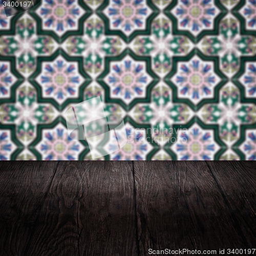 Image of Wood table top and blur vintage ceramic tile pattern wall