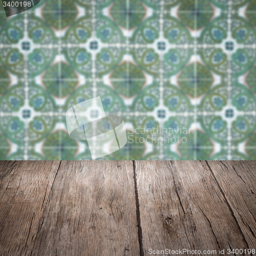 Image of Wood table top and blur vintage ceramic tile pattern wall