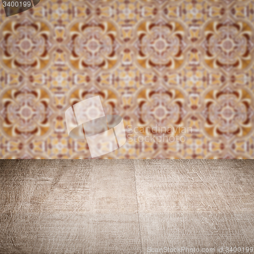 Image of Wood table top and blur vintage ceramic tile pattern wall