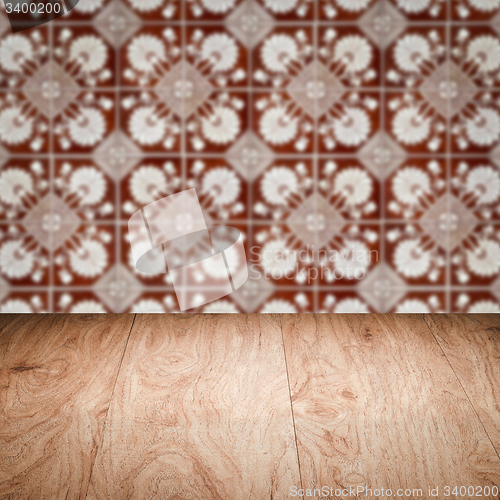 Image of Wood table top and blur vintage ceramic tile pattern wall