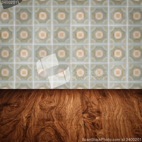 Image of Wood table top and blur vintage ceramic tile pattern wall