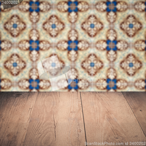 Image of Wood table top and blur vintage ceramic tile pattern wall