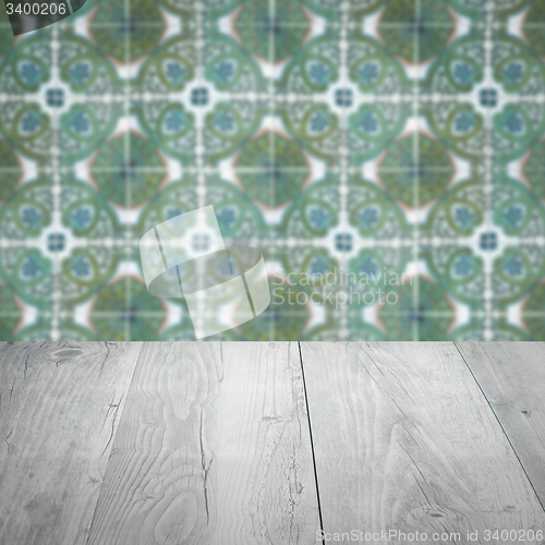 Image of Wood table top and blur vintage ceramic tile pattern wall