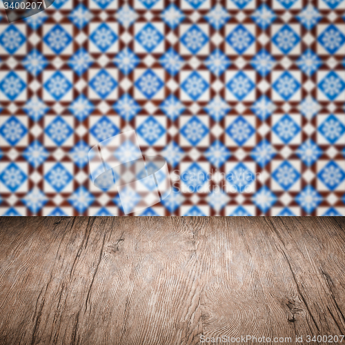 Image of Wood table top and blur vintage ceramic tile pattern wall