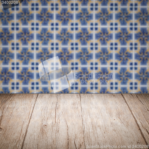 Image of Wood table top and blur vintage ceramic tile pattern wall