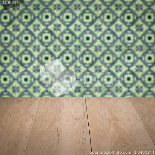 Image of Wood table top and blur vintage ceramic tile pattern wall
