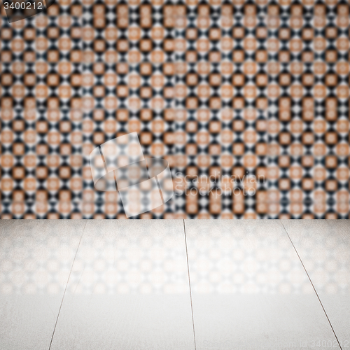 Image of Wood table top and blur vintage ceramic tile pattern wall