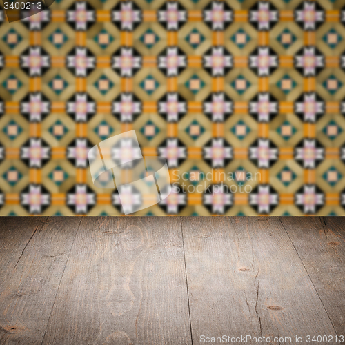 Image of Wood table top and blur vintage ceramic tile pattern wall