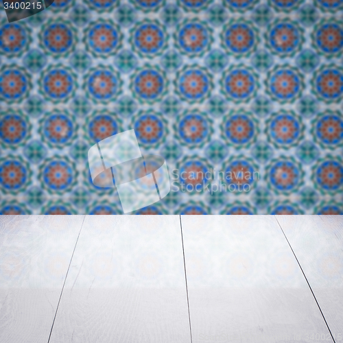 Image of Wood table top and blur vintage ceramic tile pattern wall